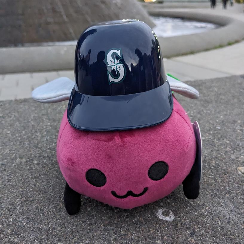 Eggbug wearing a tiny Mariners helmet